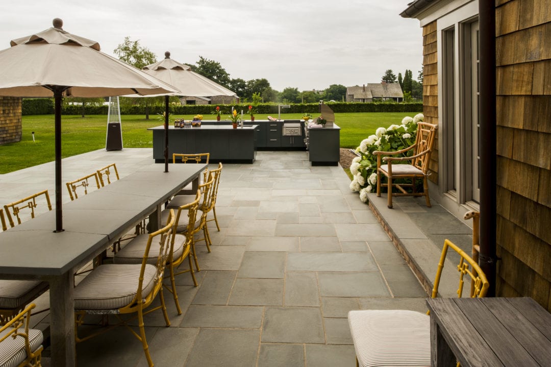 The newer trend in outdoor kitchens separates the cooking and seating areas as in this Long Island design by Blackman Outdoors with Danver stainless steel cabinetry. Photo: Steven Paul Whitsitt Photography. 